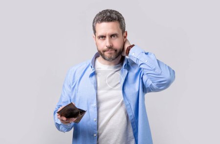 Photo for Worried moneyless man with wallet isolated on studio background. moneyless man with wallet in studio. moneyless man with wallet at hand. photo of moneyless man with wallet. - Royalty Free Image