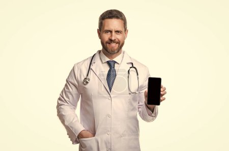 Photo for Happy medical man show telehealth isolated on white. medical man show telehealth in studio. medical man show telehealth on background. photo of medical man show telehealth on phone screen. - Royalty Free Image