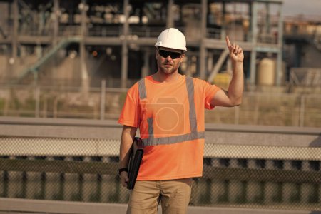 Photo for Engineer man at construction site with raised finger wearing hardhat. engineer man at construction site outdoor. f engineer man at construction site. engineer man at construction site. - Royalty Free Image