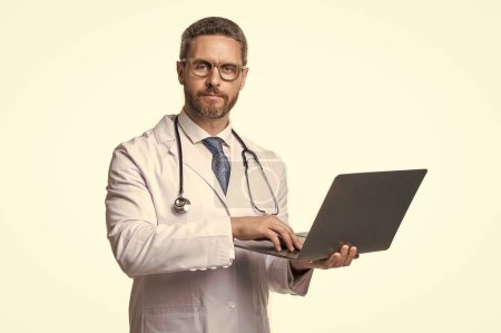 Photo for Doctor presenting emedicine on background. image of emedicine and doctor man with laptop. doctor promoting emedicine isolated on white. doctor offering emedicine in studio. - Royalty Free Image