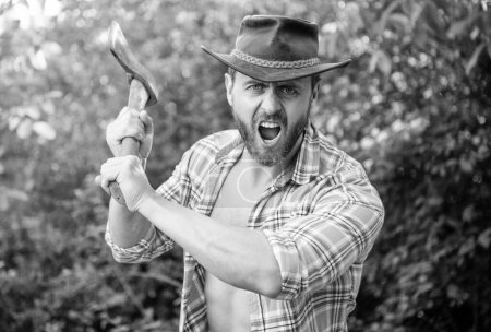 Photo for Angry lumberjack shout with axe outdoor. photo of angry lumberjack with axe. angry lumberjack with axe. angry lumberjack with axe wearing checkered shirt. - Royalty Free Image