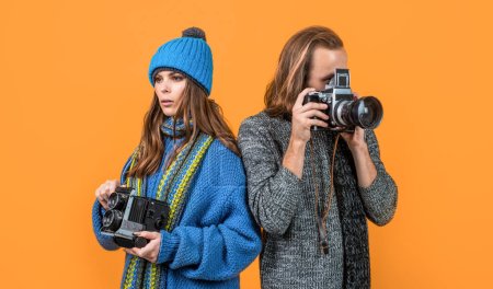 Photo for Couple of photojournalists hold photo cameras taking photograph yellow background, paparazzi. - Royalty Free Image