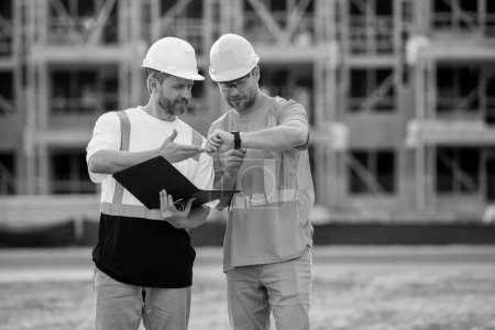 Photo for Architect men checking construction project outdoor. architect men have construction project on clipboard. photo of architect men with construction project. architect men with construction project. - Royalty Free Image