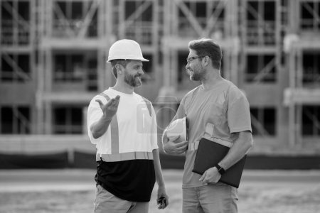 Photo for Photo of architect men with construction project. architect men with construction project. architect men discussing construction project outdoor. architect men have construction project on clipboard. - Royalty Free Image