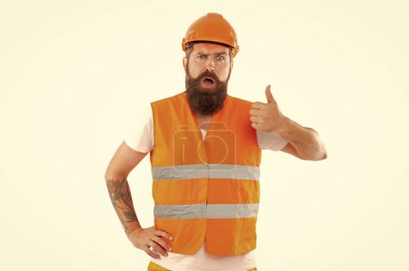 Photo for Surprised worker man in uniform. bearded worker in orange vest. studio shot of worker wearing helmet. worker isolated on white background. - Royalty Free Image