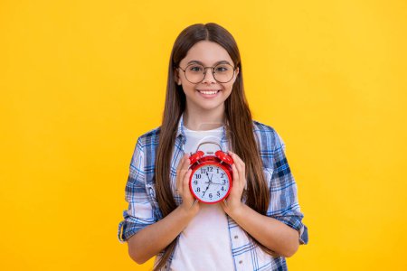 school time. Teen girl checking the clock. time schedule. Time management for teen girl. Teen girl organizing her schedule with a clock. the rhythm of the clock. Teen girl hold alarm clock.