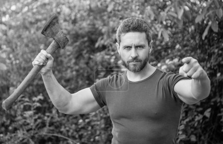 Photo for Man threatening with hatchet wearing shirt, selective focus. man threatening with hatchet outdoor. photo of man threatening with hatchet. man threatening with hatchet. - Royalty Free Image