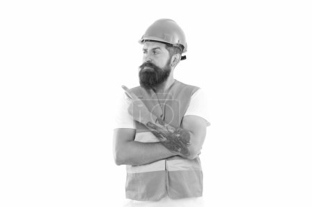 Photo for Engineer man in uniform point finger. bearded engineer in orange vest. studio shot of engineer wearing helmet. engineer isolated on white background. - Royalty Free Image
