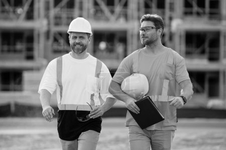 Photo for Two architect men have construction project on clipboard. photo of architect men with construction project. architect men with construction project. architect men at construction project outdoor. - Royalty Free Image
