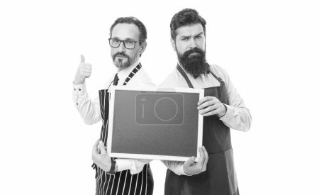 Photo for Cafe and restaurant opening. catering business. welcome on board. menu planning. happy chef team in apron. partners celebrate start up. bearded men with blackboard, copy space. This should be fine. - Royalty Free Image