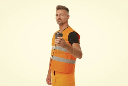 Photo for Positive contractor man in orange uniform. contractor man wearing working reflective vest. studio shot of man contractor. mature man contractor on coffee break isolated on white. - Royalty Free Image