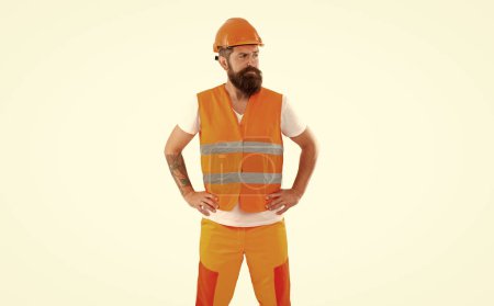 Photo for Sad builder man in uniform. bearded builder in orange vest. studio shot of builder wearing helmet. builder isolated on white background. - Royalty Free Image