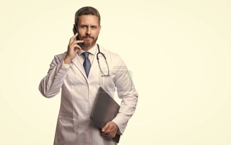 Photo for Physician online on background with copy space. photo of physician online with phone. physician online isolated on white. physician online in studio. - Royalty Free Image
