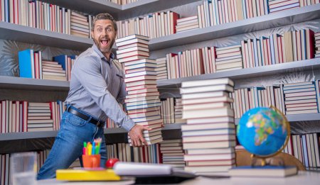 teacher with book in library classroom. hispanic teacher in college. homework. Man with books in library. Knowledge and education concept. school library. Teachers day. Teacher in school classroom.