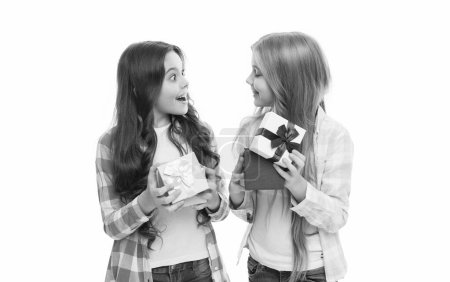 Photo for We love opening presents. Surprised cute girls opening present boxes on boxing day. Adorable little sisters holding wrapped present boxes. Small children smiling with birthday present packs. - Royalty Free Image