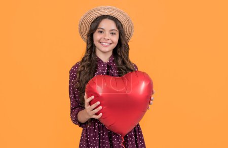 teen girl smile with red heart balloon on yellow background.