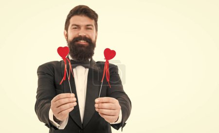 Gift with love. tuxedo man on formal event. special occasion party. male groom on wedding ceremony. going to make proposal. bearded man red hearts. love symbol. happy valentines day. love is blind.