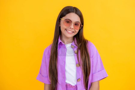 teen girl smile in stylish summer clothes. teen girl in summer stylish outfit. teen girl in summer stylish clothing enjoying weather isolated in yellow. stylish teen girl in summer studio.