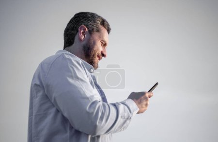 Photo for Cheerful man chat on smartphone with message. man chatting on phone messaging. smartphone communication. man chat on sky background. - Royalty Free Image