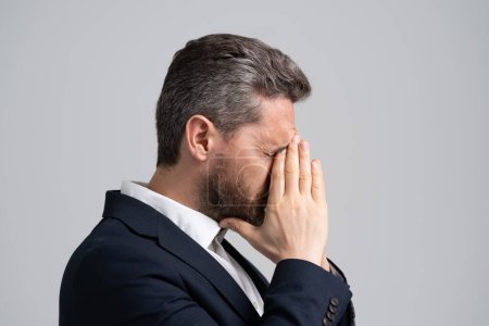 Head pain migraine. Business man in suit with migraine. Business man got migraine touches her head because of pain. Tired exhausted man suffering from headache. Business problems. Office Stress.
