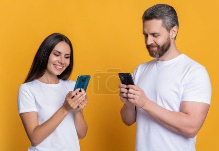 Photo for Couple chat online. Family couple blogging. Modern phone communication. Woman and man blogging using smartphone. Messaging and texting. Connected online. Chatting on phone. Virtual date. - Royalty Free Image