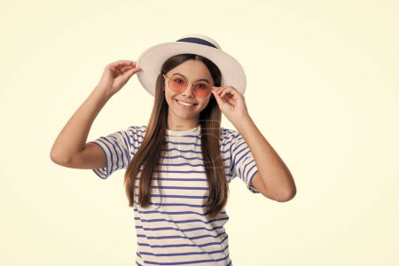 summer trendy glad teen girl in studio. photo of summer trendy teen girl wearing hat. summer trendy teen girl isolated on white. summer trendy teen girl on background.