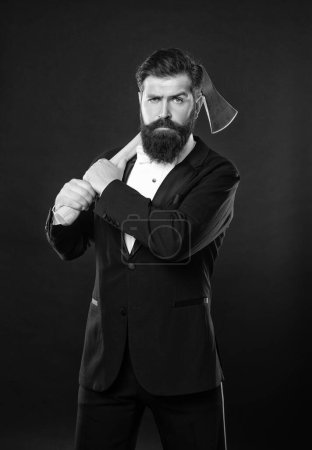 Serious unshaven guy with beard and mustache in formal suit holding axe dark background, bearded man.