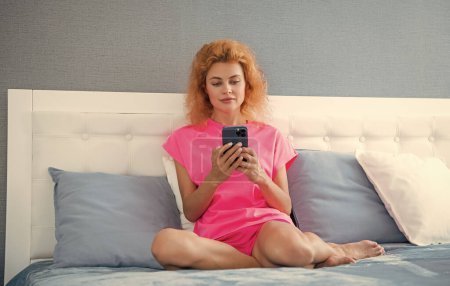 girl relax at home and texting on phone. girl texting on phone on the bed. phone texting of girl.