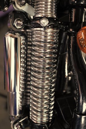 Metallic chrome custom hydraulic shock absorber or rear suspension shock motorcycle custombike part detailed.