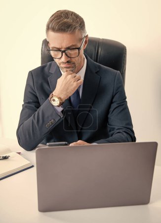 busy businessman in eyewear using smartphone in office with computer.