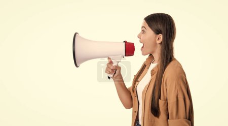 shouting teen girl announcer hold loudspeaker in studio. teen girl announcer with loudspeaker. photo of teen girl announcer hold loudspeaker. attention. teen girl announcer with loudspeaker