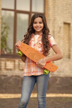Photo for Skateboarding of happy teen girl outdoor. skateboarding of teen girl outside. skateboarding of teen girl in the street. photo of teen girl skateboarding. - Royalty Free Image