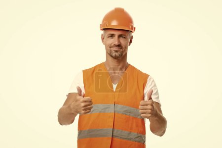 man engineer showing thumb up in white studio. man engineer on background. photo of man engineer wearing reflective vest. man engineer isolated on white.