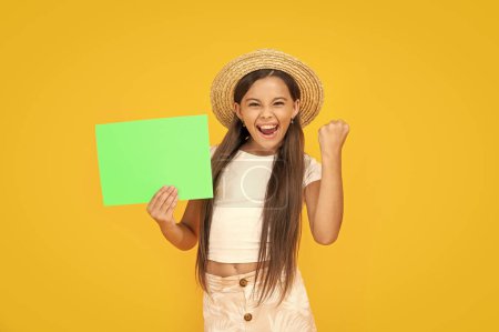 successful teen girl with copy space on green paper on yellow background.