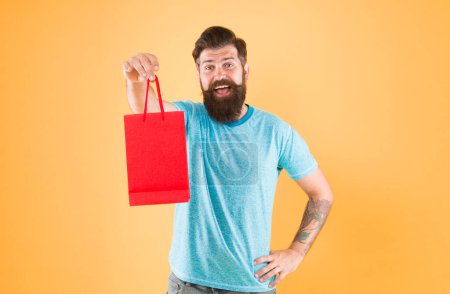 take advantages from sale. Buy product. bearded man go shopping. Shopping concept. mature male cheerful with fashion purchase. small present. Happy hipster hold paper bag. Man with purchase.