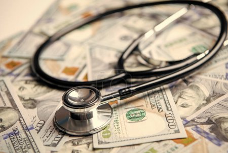 closeup photo of medicine expenses currency. medicine expenses concept. money for medicine expenses in selective focus. stethoscope of medicine expenses closeup.
