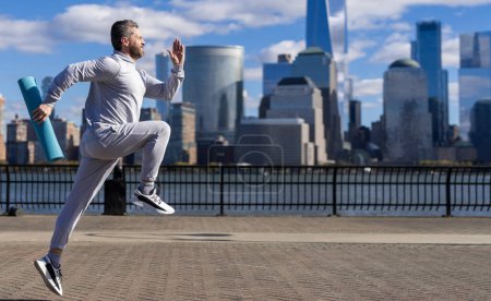 Morning sport workout jogger run in New York. The jogger run at sport training. Sportsman jogger running or jogging. Man in sports suit training jogging. Running man in Manhattan. Copy space.
