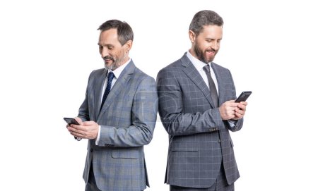 Photo for Two texting businessmen chatting in blog. businessmen texting on phone isolated on white. business texting message. online business. business men in suit use phone. Message spam. - Royalty Free Image