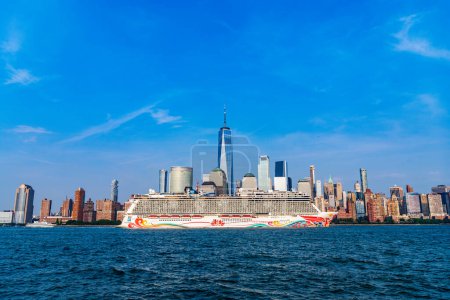 Photo for New York, USA - June 13, 2023: Cruise ship Norwegian Joy Sailing next to Manhattan in New York. Skyline of New York Manhattan cruising on the Hudson River cruise liner NCL. - Royalty Free Image