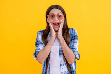 surprised teen girl in sunglasses and checkered shirt feel the surprise.