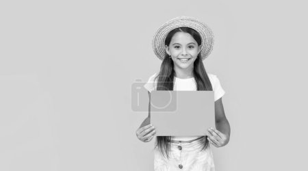 glad teen girl with copy space on orange paper on yellow background.
