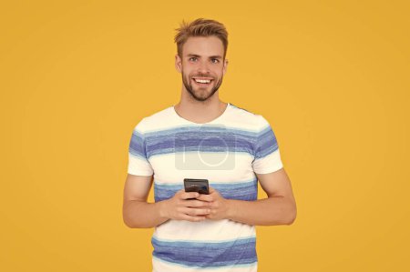 Photo for Glad man uses phone to text or message making communication easy and convenient. man uses phone to make effective communication. man has phone communication. digital communication of man with phone. - Royalty Free Image