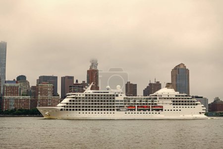 Photo for Cruise ship sailing next Manhattan in New York. Skyline of New York Manhattan cruising on the Hudson River cruise liner . Vacation on cruise liner - Royalty Free Image