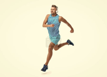 sport jogger listen to music. The jogger ran at sport training isolated on white. In a morning sport workout jogger run in studio. The jogger stretched legs before running.