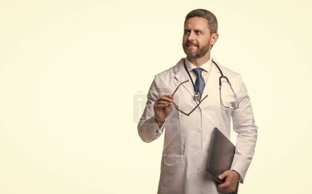 Photo for Doctor promoting emedicine isolated on white, copy space. doctor offering emedicine in studio. doctor presenting emedicine on background. photo of emedicine and doctor man with laptop. - Royalty Free Image