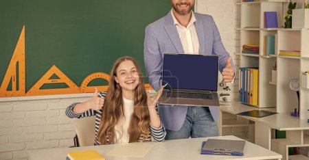 happy student with school teacher presenting laptop screen with copy space.