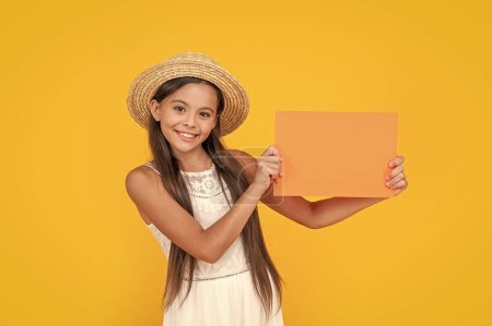 teen child smile with copy space on orange paper on yellow background.