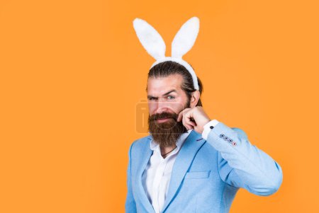 bearded man wear bunny ears. Egg hunt. spring holiday celebration. funny male hipster. brutal man having fun. mature male wear rabbit ears. easter bunny man. happy easter. Easter fun.