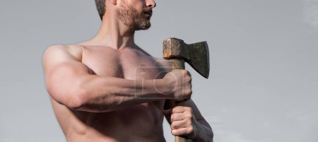 shirtless male with axe. caucasian male hold ax. brutal male on sky background.