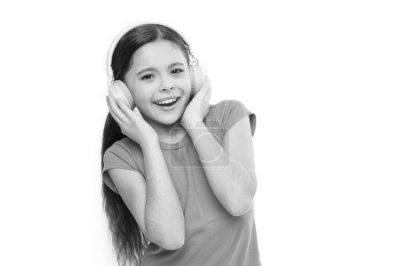 Little girl listen music modern headphones. Small kid listen music headphones. No ad interruptions. Play any song. Try premium account. Enjoy nonstop music. Privilege of premium music account.